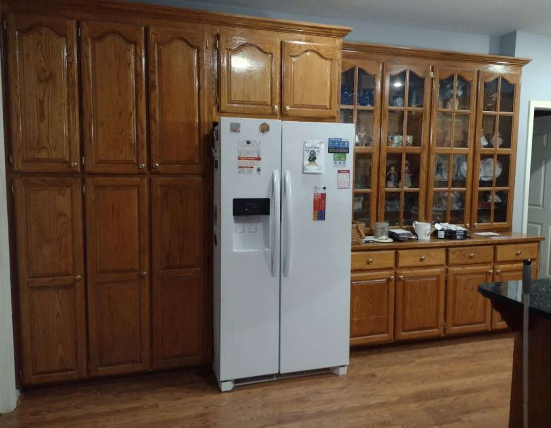 Before: light honey-toned oak pantry cabinets and display cases