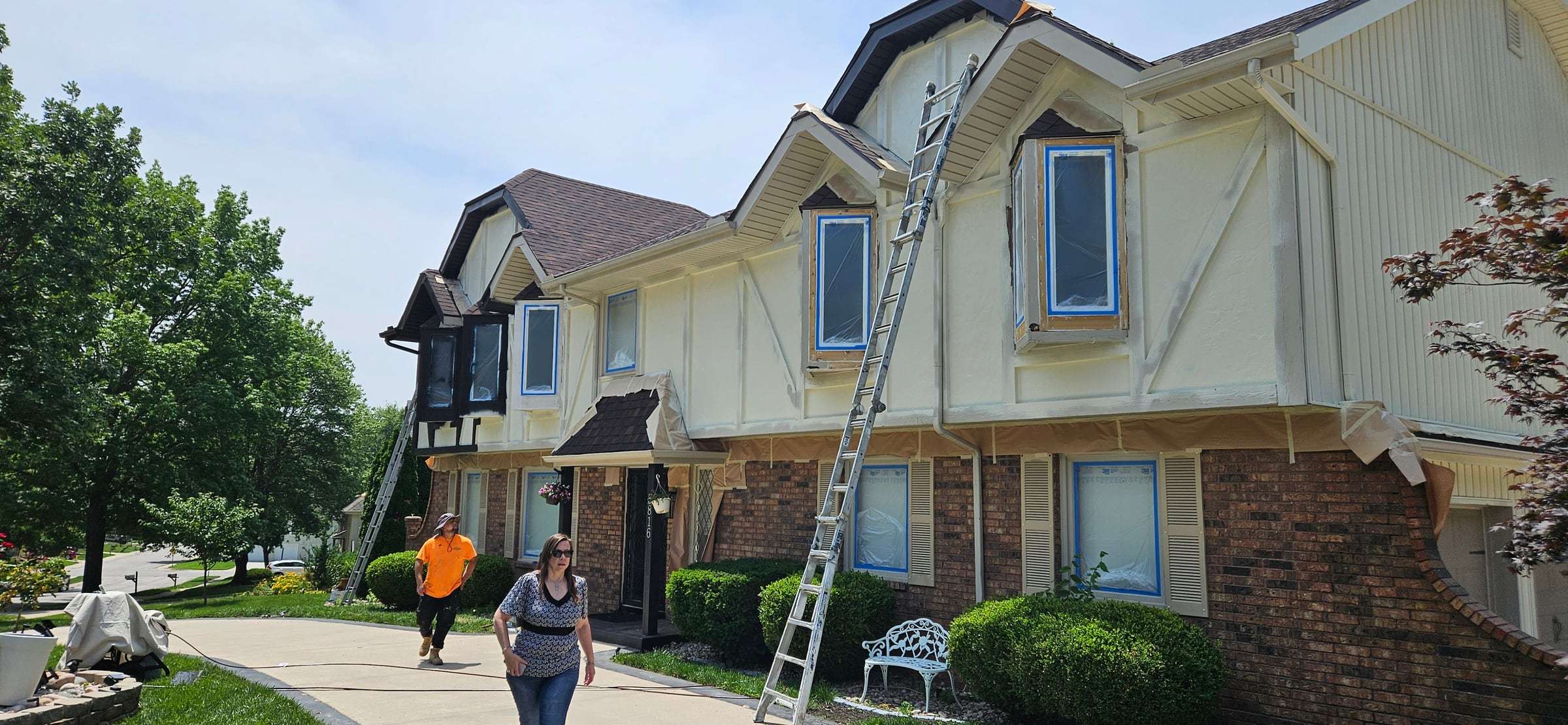 Close view of masked windows and primed trim during preparation