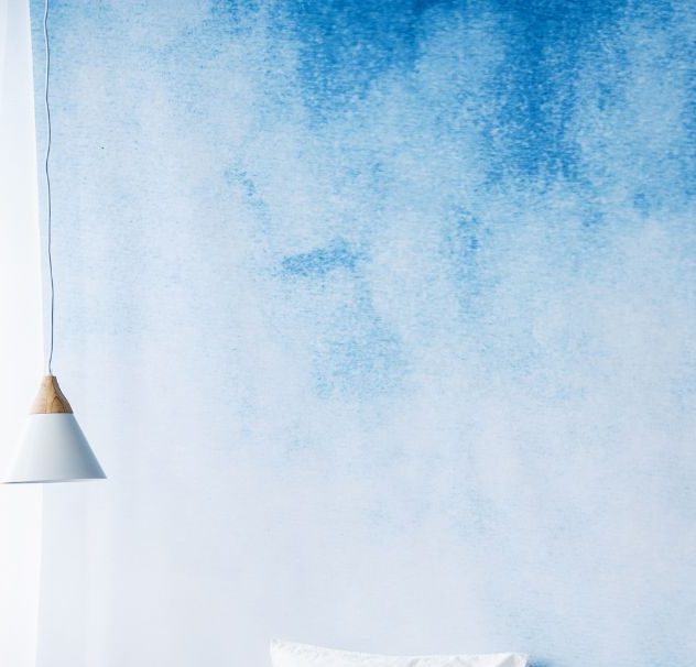 Ombre gradient wall painted in soft blue tones creating a calming effect in a modern Kansas City bedroom